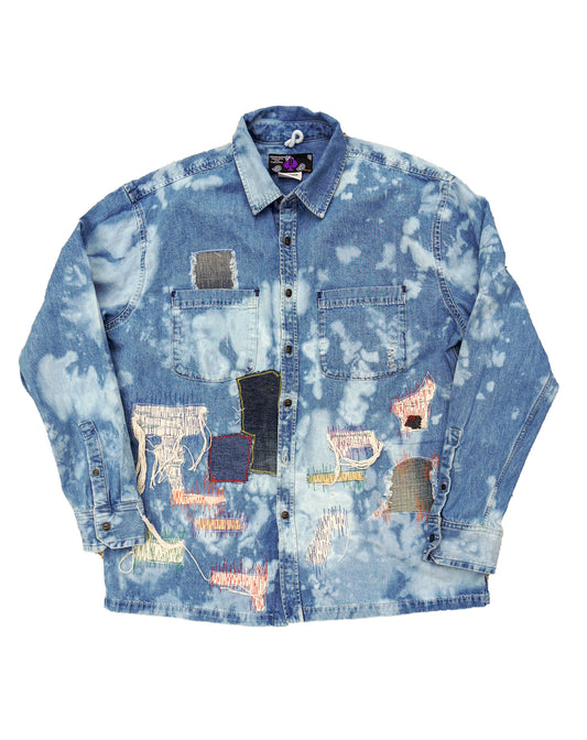 Denim Shirt distressed and faded. The shirt is enhanced with multi color stitching 